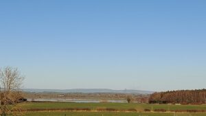 A view over Dereen on a clear day. A temporary soccer field is in the foreground.